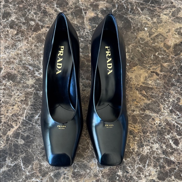 Prada Shoes - Prada black classic logo pumps modellerie gold logo sz 38.5